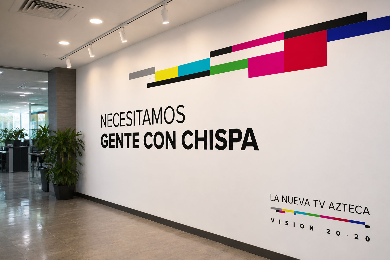 Muro de oficina con bloques de color y el mensaje "Necesitamos gente con chispa"