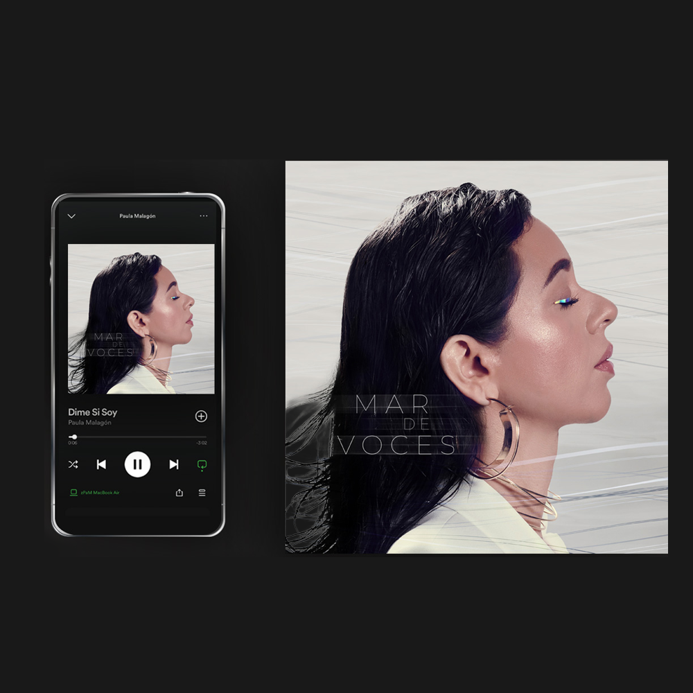 Teléfono móvil con el reproductor de Spotify mostrando la canción "Dime si soy" junto a la portada de Mar de Voces con un retrato de perfil